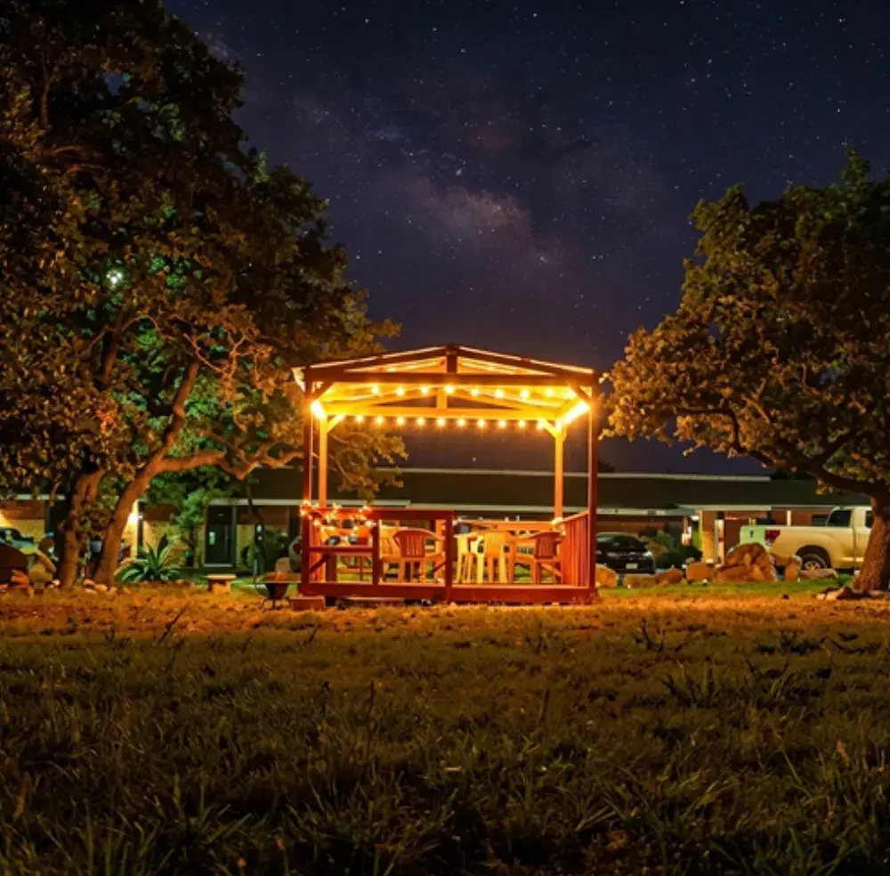 String lights on the pergola under a starry Hill Country sky